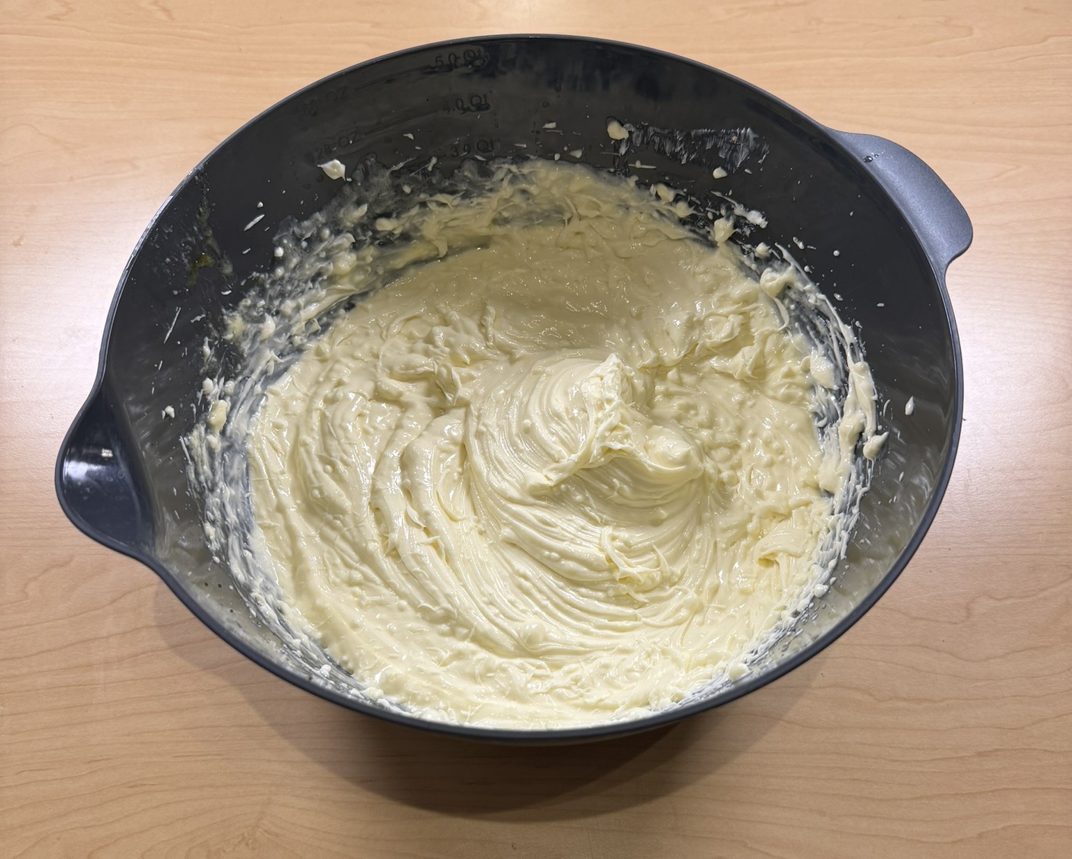 Mixing eggs and cream cheese